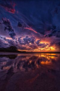 Scenic view of lake against romantic sky at sunset