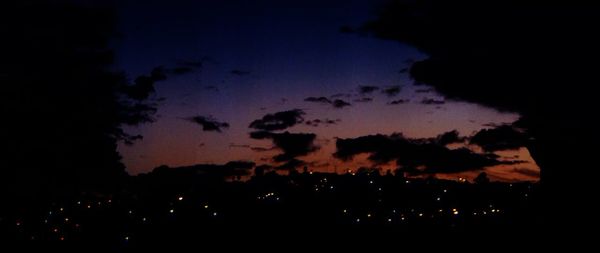 Low angle view of silhouette landscape against sky at night