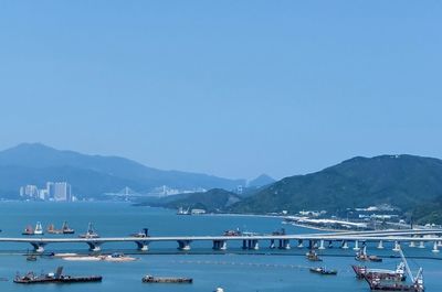 View of boats in sea against blue sky