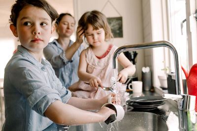 Women and woman in kitchen at home