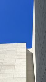 Low angle view of modern building against clear blue sky