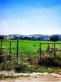 Scenic view of grassy field against cloudy sky