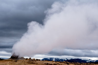 Smoke emitting from volcanic mountain against sky