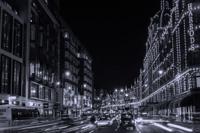 Illuminated city street and buildings at night