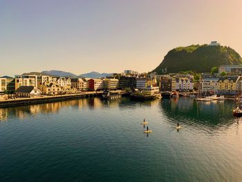 Scenic view of buildings and mountains against clear sky