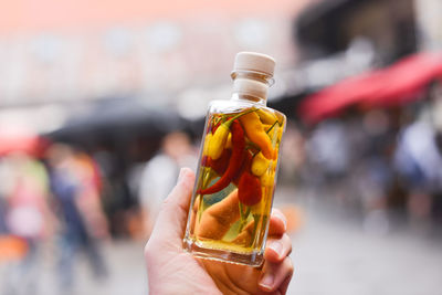 Close-up of hand holding bottle