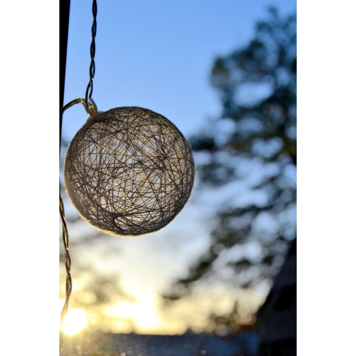 hanging, close-up, transfer print, focus on foreground, sphere, lighting equipment, auto post production filter, low angle view, decoration, light bulb, metal, no people, tree, indoors, nature, day, electricity, selective focus, fruit