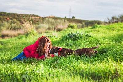 Woman with dog on field