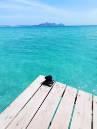 Scenic view of swimming pool by sea against sky