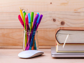 Close-up of school supplies on wooden table
