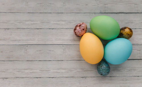 High angle view of multi colored eggs on table