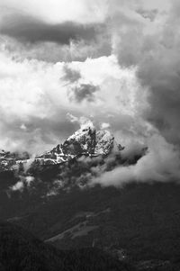 Majestic view of clouds surrounding snowcapped mountain