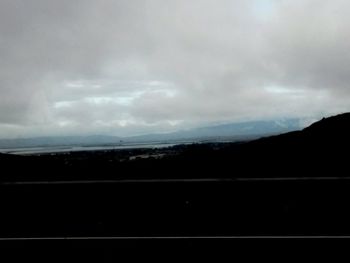 Scenic view of mountains against cloudy sky