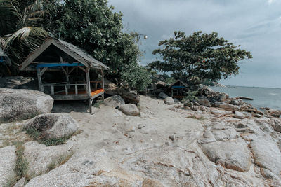 View of hut on beach against sky