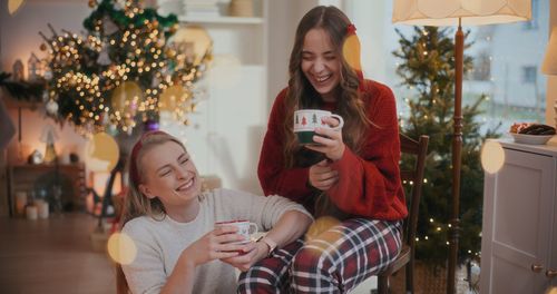 Portrait of mother and daughter sitting at home