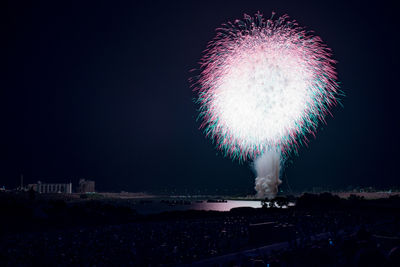 Low angle view of firework display at night