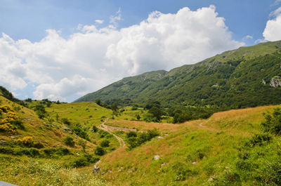 Scenic view of mountains against cloudy sky