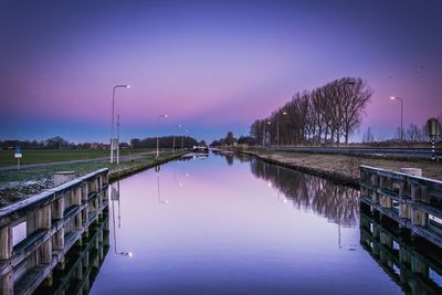 Scenic view of lake against sky at dusk