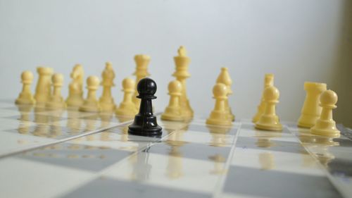 Close-up of pawn and chess pieces on board