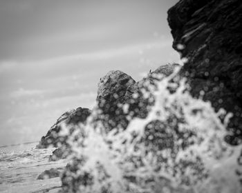 Portrait of man against rock formation in sea