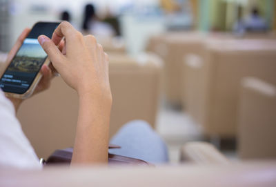 Midsection of man using mobile phone