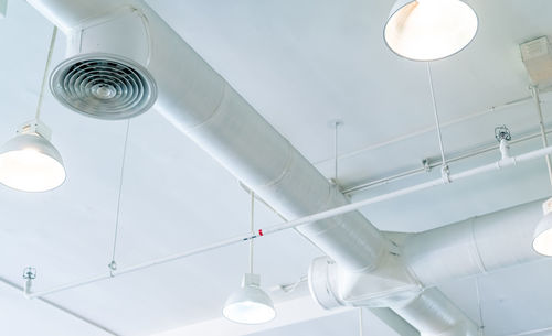 Air duct, air conditioner pipe and fire sprinkler system on white ceiling wall. air flow .