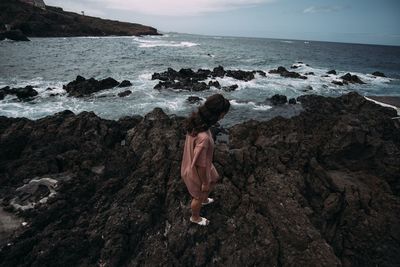 Woman looking at sea shore