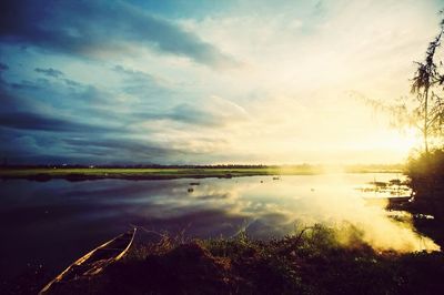 Scenic view of lake at sunset