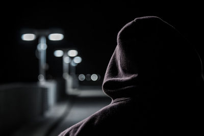 Rear view of woman against black background