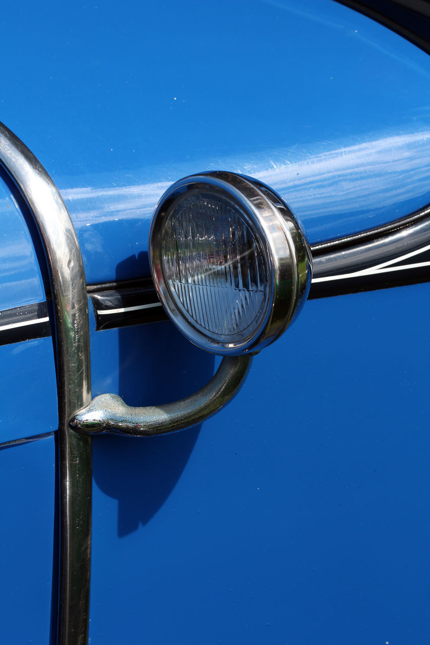 CLOSE-UP OF BLUE REFLECTION ON METAL MIRROR