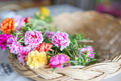 Close-up of pink flowers in basket on table