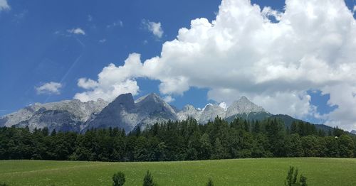 Panoramic view of green landscape against sky