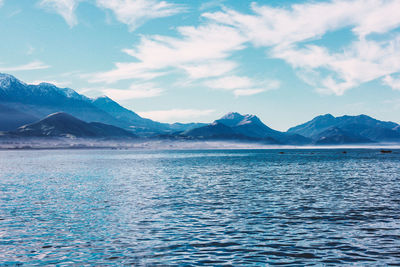 Scenic view of lake and mountains against sky