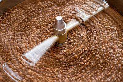 Close-up of coffee being cooled from roasting 