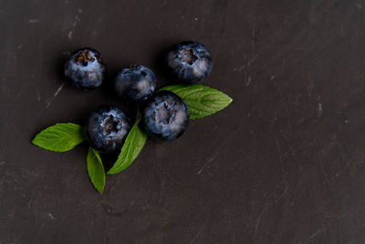 High angle view of fruits and leaves on table