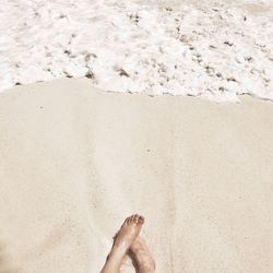 Feet on sandy beach