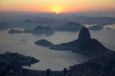 High angle view of silhouette mountains against sky during sunrise