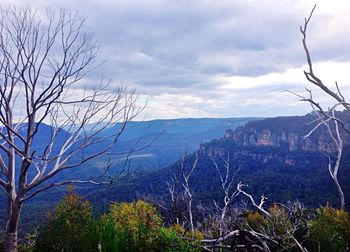 Scenic view of mountains against cloudy sky