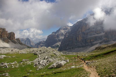 Scenic view of mountains against cloudy sky