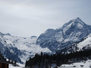 Scenic view of snow covered mountains against sky