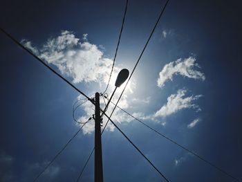 Low angle view of electricity pylon against sky