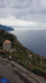 High angle view of buildings by sea against sky