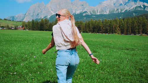 Full length of man wearing sunglasses standing on field