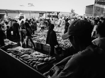 Crowd in city against sky