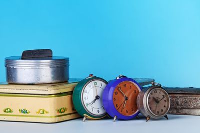 Close-up of clock against blue sky