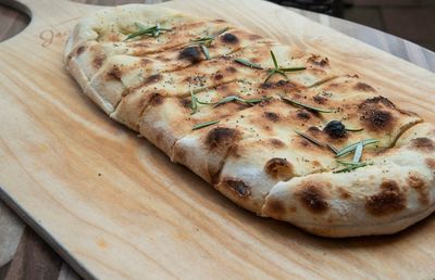 High angle view of pizza on cutting board