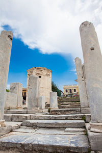 Tourists visiting the ancient ruins at the roman agora in athens