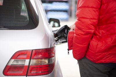 Man's hand is refuelling gas or oil in the refuelling station prepare transport to travel