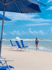 Man standing on beach against sky