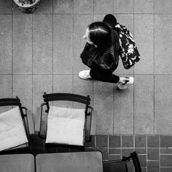 High angle view of woman sitting on tiled floor